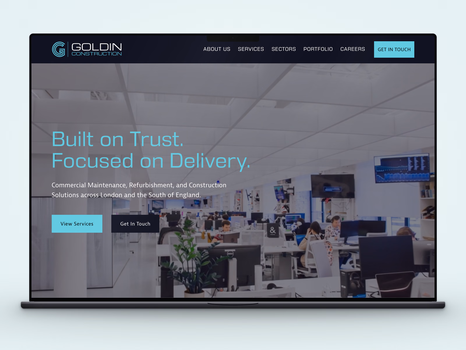 Goldin Construction website displayed on a laptop