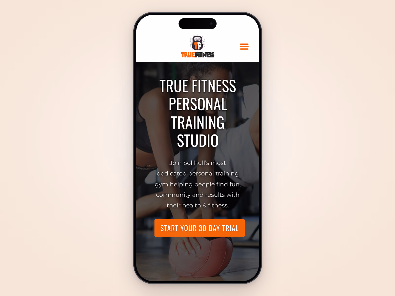True Fitness Studio website displayed on a mobile phone